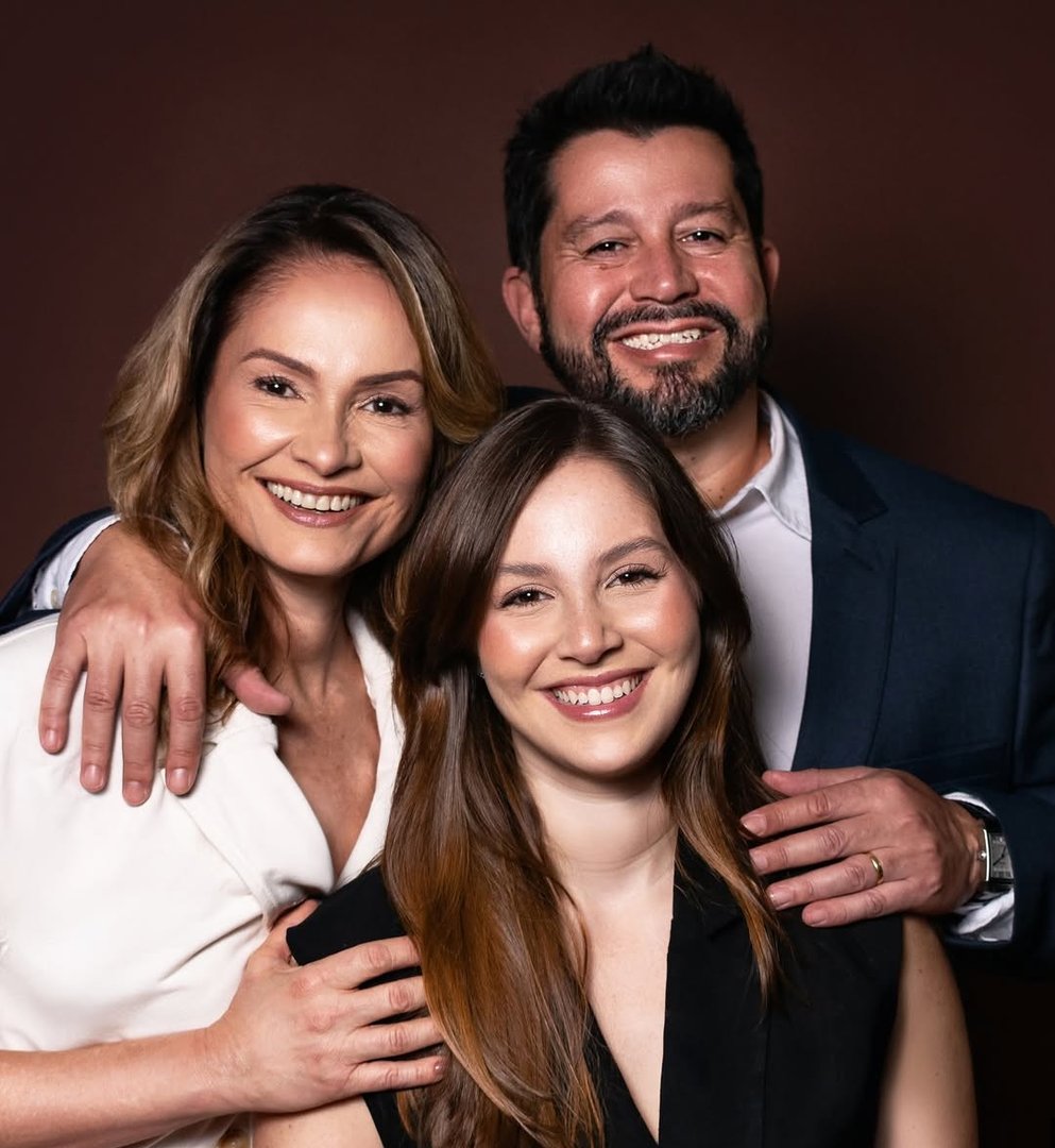 Família em ambiente de clínica odontológica, representando atendimento humano e acolhedor